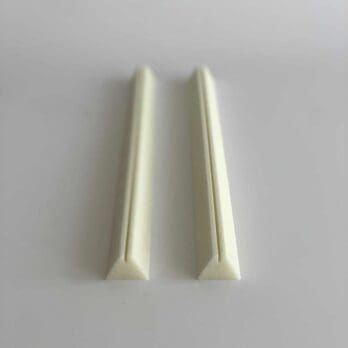 Polyurethane alarm wire holders for securing alarm wire under foam insulation of pipes.